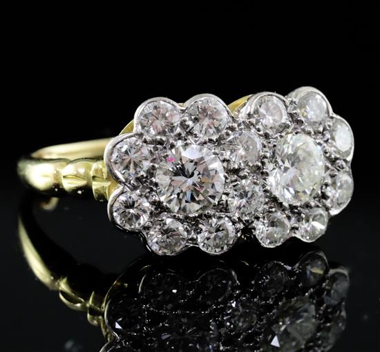 An 18ct yellow gold, platinum and diamond double cluster ring, approx 2.2ct total, size N.